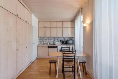 a small kitchen with a wooden table and chairs at Appartement du Mont - Résidence La Vardaffe - Welkeys in Chamonix-Mont-Blanc