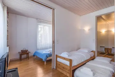 a bedroom with two beds and a mirror at Appartement du Mont - Résidence La Vardaffe - Welkeys in Chamonix-Mont-Blanc