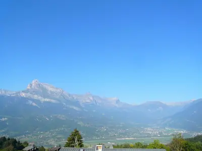 a view of a mountain range with a city at Résidence Les Cristaux Du Haut - Cristaux 51 MAE-5310 in Combloux