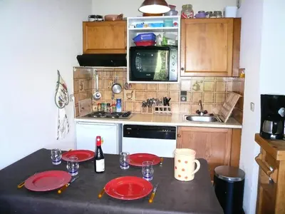 a kitchen with a table with red plates on it at Résidence Les Granges D'ormaret - Grandes d'Ormaret 16 MAE-5318 in Combloux