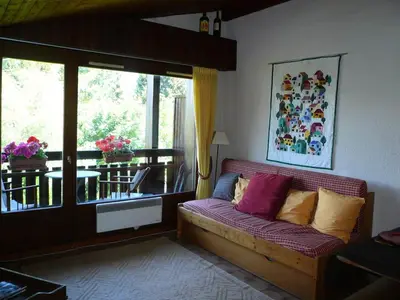 a living room with a couch and a balcony at Résidence Les Granges D'ormaret - Grandes d'Ormaret 16 MAE-5318 in Combloux