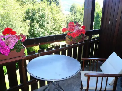 a table and chairs on a balcony with flowers at Résidence Les Granges D'ormaret - Grandes d'Ormaret 16 MAE-5318 in Combloux