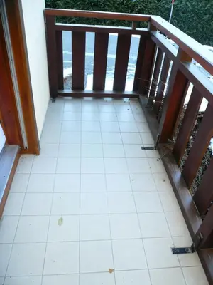 a balcony with a tiled floor and a wooden railing at Résidence Perle Des Neiges - Perles des Neiges 1 MAE-5319 in Combloux