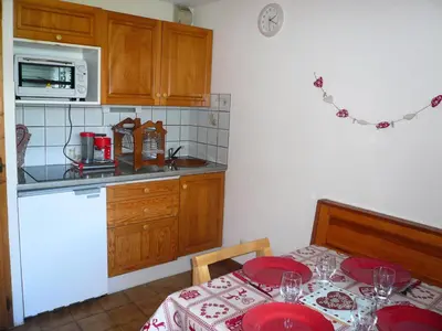 a kitchen with a table with red plates on it at Résidence Perle Des Neiges - Perles des Neiges 1 MAE-5319 in Combloux