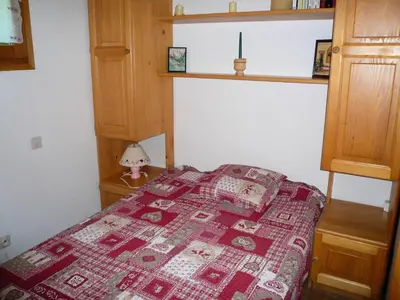 a bedroom with a bed with a red and white quilt at Résidence Perle Des Neiges - Perles des Neiges 1 MAE-5319 in Combloux
