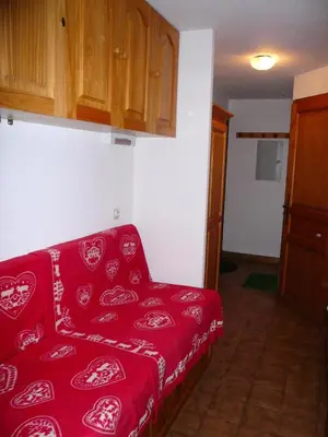 a living room with a red couch in a room at Résidence Perle Des Neiges - Perles des Neiges 1 MAE-5319 in Combloux