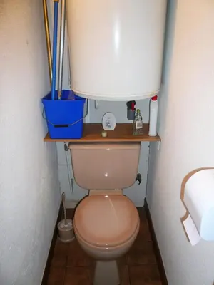 a bathroom with a toilet with a wooden shelf above it at Résidence Perle Des Neiges - Perles des Neiges 1 MAE-5319 in Combloux