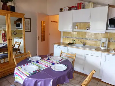 a kitchen with a table with a purple table cloth at Résidence Le Royal - Royal 16 MAE-5321 in Combloux