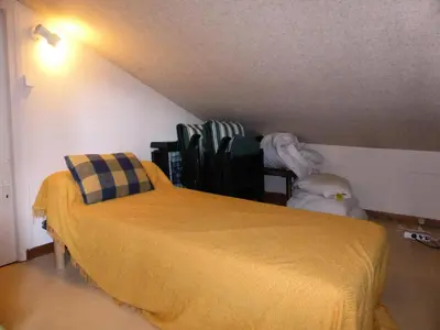 a bedroom with a bed with a yellow blanket at Résidence Le Royal - Royal 16 MAE-5321 in Combloux