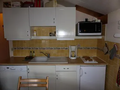 a kitchen with white cabinets and a sink and a microwave at Résidence Le Royal - Royal 16 MAE-5321 in Combloux