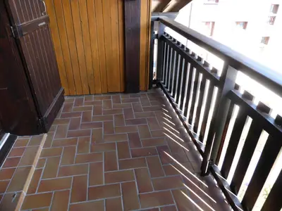a staircase with a brown tile floor and a railing at Résidence Le Royal - Royal 16 MAE-5321 in Combloux