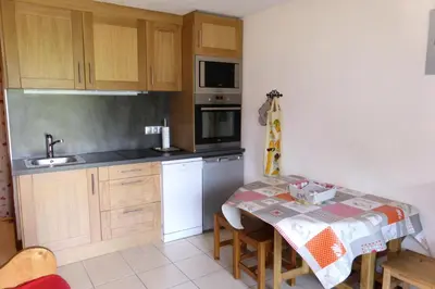 a small kitchen with a table and a sink at Résidence Gros Cailloux Amethyste - Gros Cailloux A7 MAE-5328 in Combloux