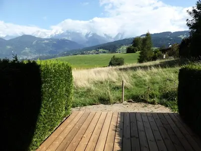 a wooden walkway with a view of mountains at Résidence Gros Cailloux Amethyste - Gros Cailloux A7 MAE-5328 in Combloux