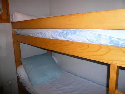 a bunk bed with a blue pillow on the bottom bunk at Résidence Les OrÉades - Oréades B04 MAE-5329 in Combloux