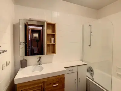 a white bathroom with a sink and a shower at Charmant studio près du centre de Combloux avec kitchenette - FR-1-560-54 in Combloux