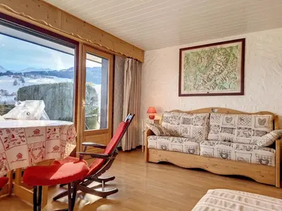 a living room with a couch and a table at Charmant studio près du centre de Combloux avec kitchenette - FR-1-560-54 in Combloux