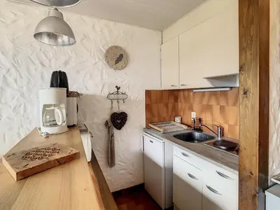 a kitchen with a counter with a coffee maker and a sink at Charmant studio près du centre de Combloux avec kitchenette - FR-1-560-54 in Combloux