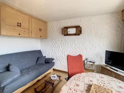 a living room with a couch and a table at Charmant studio près du centre de Combloux avec kitchenette - FR-1-560-54 in Combloux