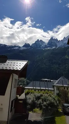 a view of a mountain range with mountains in the background at Appartement typique,chaleureux et pratique in Chamonix-Mont-Blanc