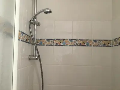 a shower with a shower head in a bathroom at Appartement typique,chaleureux et pratique in Chamonix-Mont-Blanc