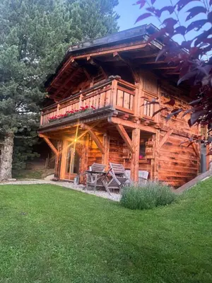 a log cabin with a porch and a balcony at BARMADZA Mazots de Charme in Demi-Quartier