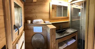 a small bathroom with a sink and a mirror at BARMADZA Mazots de Charme in Demi-Quartier
