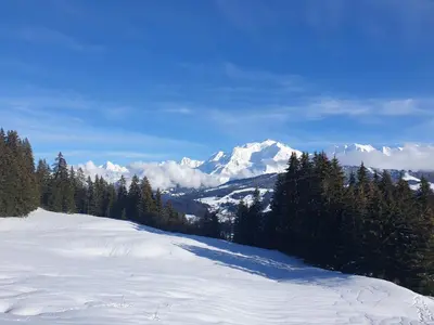 a snow covered slope with a mountain in the background at BARMADZA Mazots de Charme in Demi-Quartier
