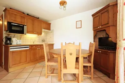 a kitchen with a table and chairs and a microwave at Résidence Les Hauts De Chavants - Hauts de Chavants Bellachat 1 MAE-7730 in Les Houches