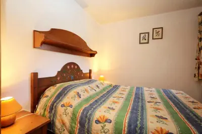 a bedroom with a bed with a colorful comforter at Résidence Les Hauts De Chavants - Hauts de Chavants Bellachat 1 MAE-7730 in Les Houches