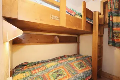 a bunk bed in a room with a bed at Résidence Les Hauts De Chavants - Hauts de Chavants Bellachat 1 MAE-7730 in Les Houches