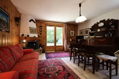a living room with a red couch and a table at Résidence Les Eaux Rousses - Les Eaux Rousses MAE-9964 in Les Houches