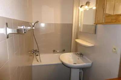 a bathroom with a sink and a toilet and a tub at Résidence Le Royal - Royal 12 MAE-9034 in Combloux