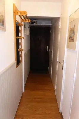 a hallway with a black door and a wooden floor at Résidence Le Royal - Royal 12 MAE-9034 in Combloux