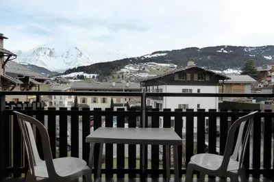 a table and chairs on a balcony with a mountain at Résidence Le Royal - Royal 12 MAE-9034 in Combloux