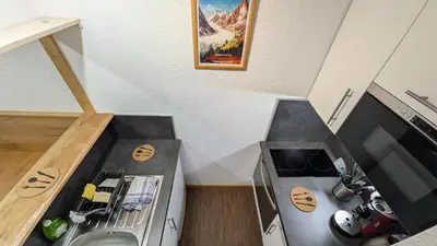 a small kitchen with a sink and a stove at L'alpage in Chamonix-Mont-Blanc