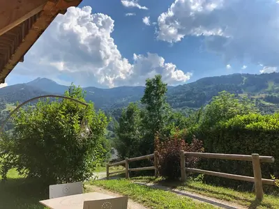 a bench with a view of the mountains at Chalet Cosy in Saint-Gervais-les-Bains