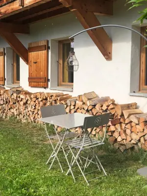 a table and two chairs in front of a house at Chalet Cosy in Saint-Gervais-les-Bains