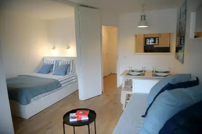 a living room with a bed and a table at Appartement Cosy - Aiguille du Midi in Chamonix-Mont-Blanc
