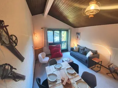 a living room with a couch and a table at Chamonix - superbe appartement vue Mont Blanc in Chamonix-Mont-Blanc