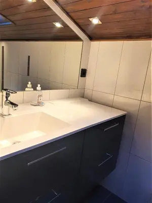 a bathroom with a sink and a large mirror at Chamonix - superbe appartement vue Mont Blanc in Chamonix-Mont-Blanc