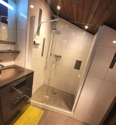 a shower with a glass door in a bathroom at Chamonix - superbe appartement vue Mont Blanc in Chamonix-Mont-Blanc