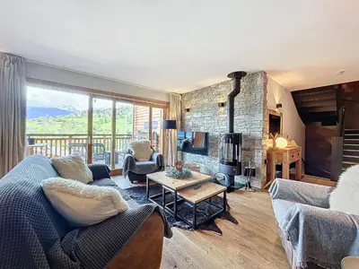a living room with a couch and a fireplace at Demi-chalet de luxe avec piscine et vue Mont Blanc - FR-1-560-71 in Combloux