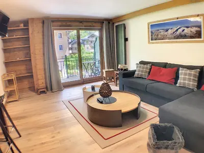 a living room with a couch and a table at Grey Squirrel Home in Chamonix-Mont-Blanc