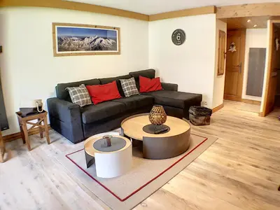 a living room with a couch and a table at Grey Squirrel Home in Chamonix-Mont-Blanc