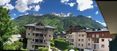 a group of buildings with mountains in the background at Grey Squirrel Home in Chamonix-Mont-Blanc
