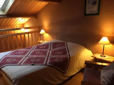 a bedroom with a bed and two lamps on tables at Le Battieu in Samoëns