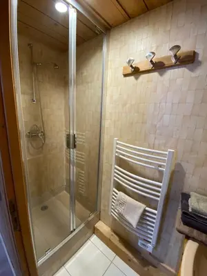 a shower in a bathroom with a glass shower stall at Le Battieu in Samoëns