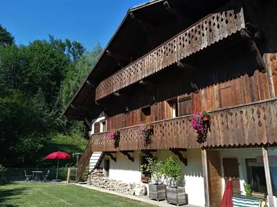 a building with a balcony with flowers on it at Le Battieu in Samoëns