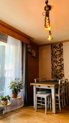 a dining room with a table and chairs and a window at Appartement vue Montblanc 5mn piste1 in Les Houches
