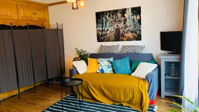 a bedroom with a bed with a yellow blanket at Appartement vue Montblanc 5mn piste1 in Les Houches
